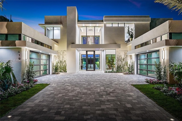 back house at dusk with french doors