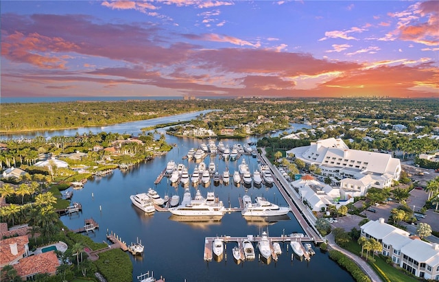 aerial view at dusk featuring a water view