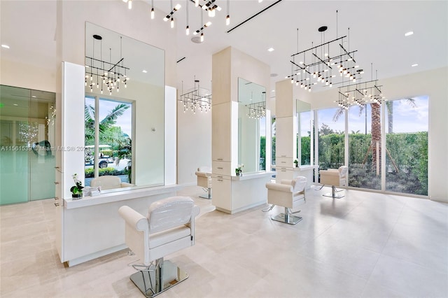 bathroom featuring a towering ceiling and a healthy amount of sunlight