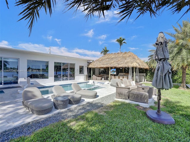 view of swimming pool with a patio, an outdoor hangout area, and a lawn