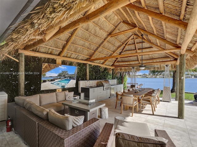 view of patio with a water view, a gazebo, an outdoor kitchen, grilling area, and an outdoor living space