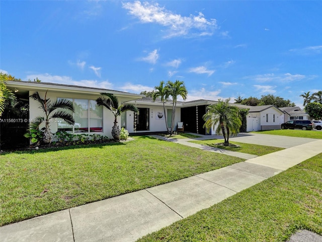 ranch-style home with a front yard and a garage