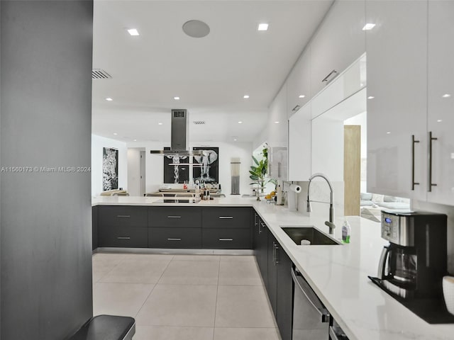 kitchen featuring white cabinetry, sink, light tile floors, light stone counters, and dishwasher