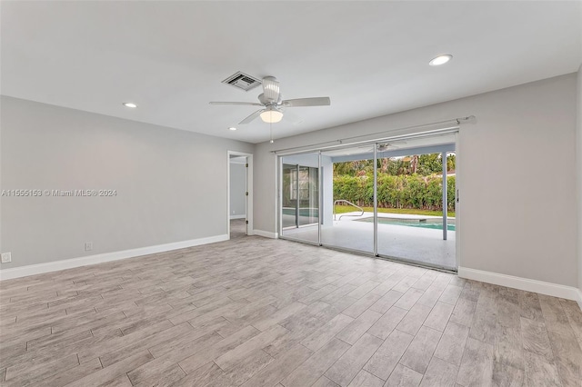 empty room featuring ceiling fan and light hardwood / wood-style flooring