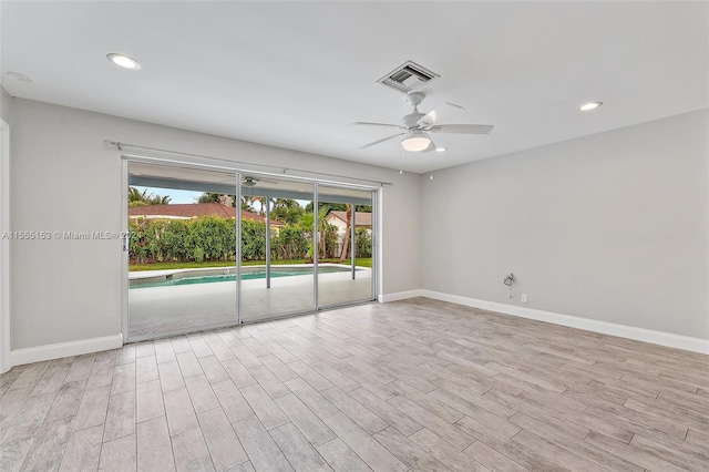 spare room with ceiling fan, light hardwood / wood-style floors, and a healthy amount of sunlight