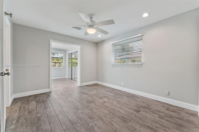 empty room featuring ceiling fan and light hardwood / wood-style flooring