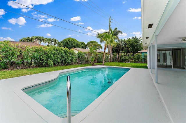 view of swimming pool featuring a patio area and ceiling fan