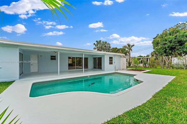 view of swimming pool featuring a lawn and a patio