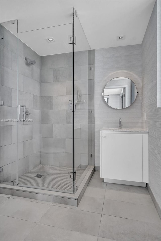 full bath featuring a stall shower, vanity, and tile patterned flooring