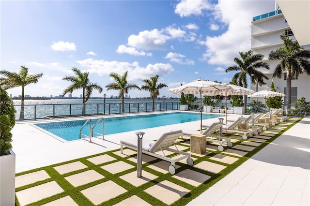 community pool featuring fence and a patio area