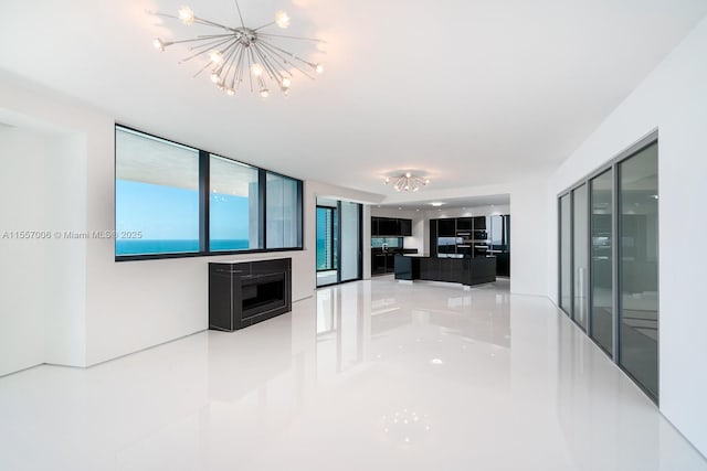 unfurnished living room with a notable chandelier