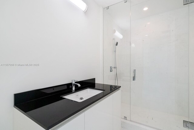 bathroom featuring walk in shower and sink