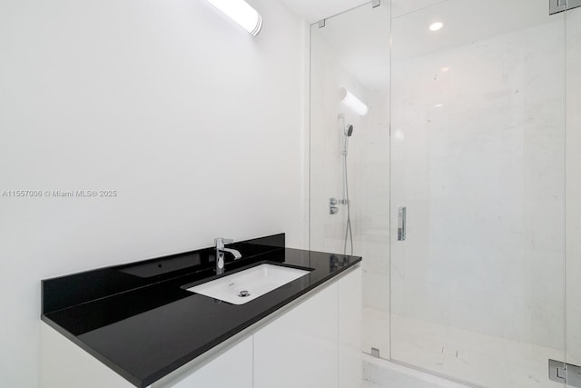 bathroom with vanity and a shower with shower door