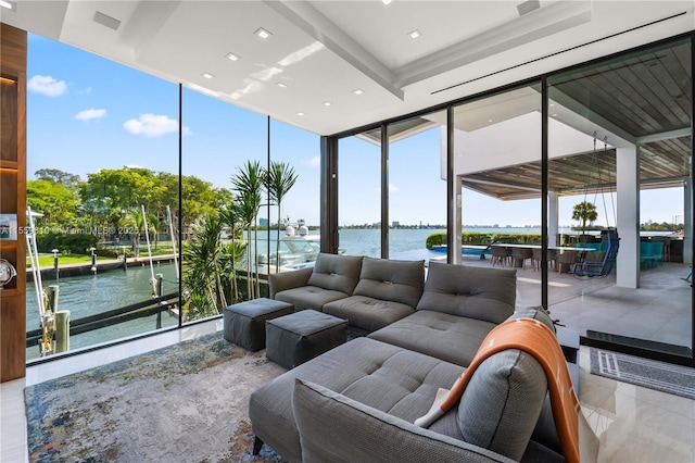 sunroom / solarium with a water view and a healthy amount of sunlight