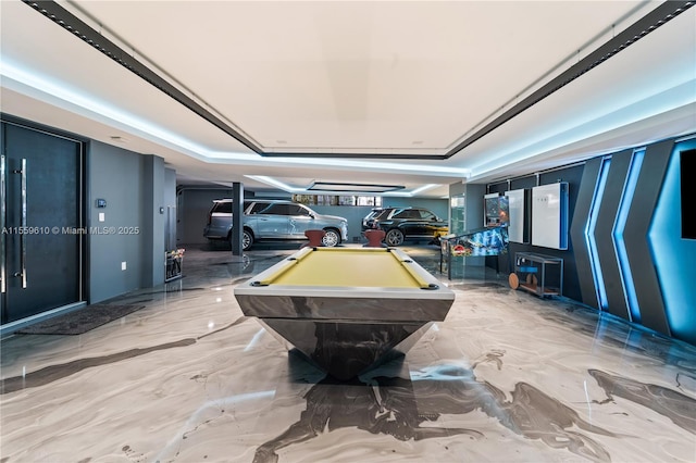 game room featuring a tray ceiling and billiards