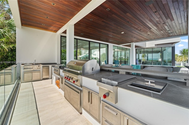 view of patio with sink, an outdoor kitchen, and a grill