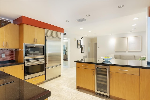 kitchen featuring built in appliances and beverage cooler