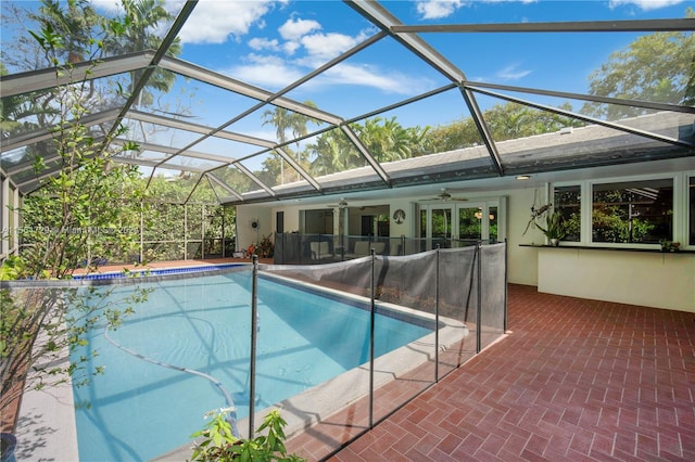 view of pool featuring a patio area, ceiling fan, and a lanai