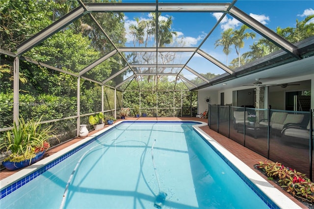 view of pool featuring ceiling fan and a lanai