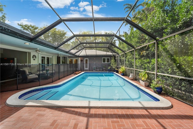 view of pool with a patio area, ceiling fan, and a lanai