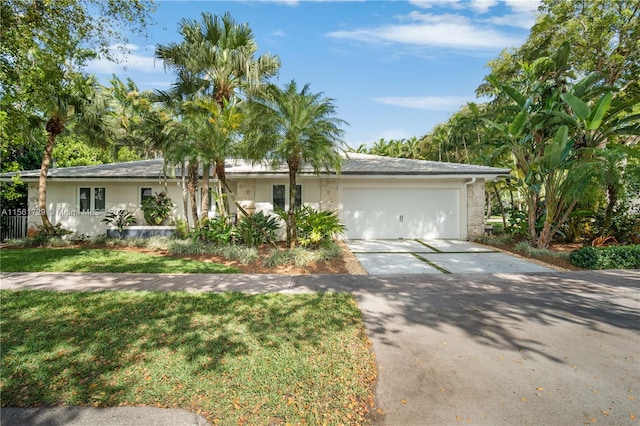 single story home with a front lawn and a garage