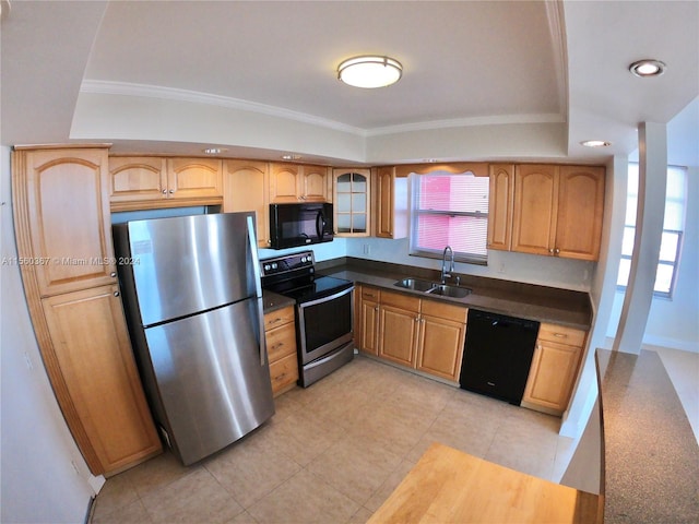 kitchen with a tray ceiling, black appliances, light tile flooring, sink, and crown molding