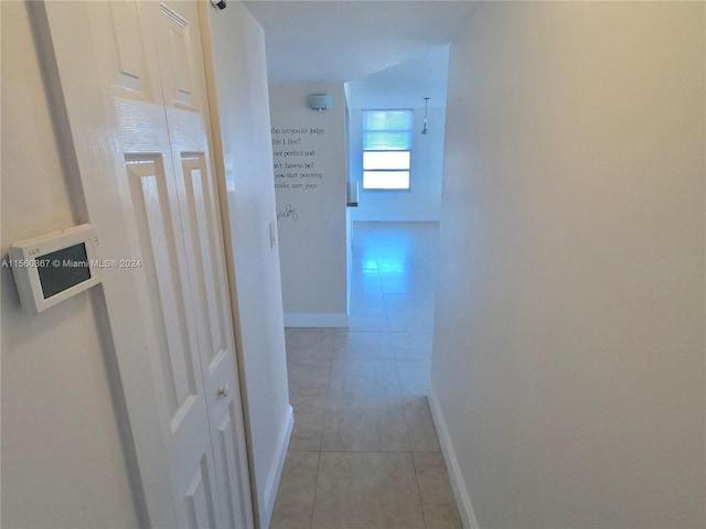 hallway featuring light tile flooring