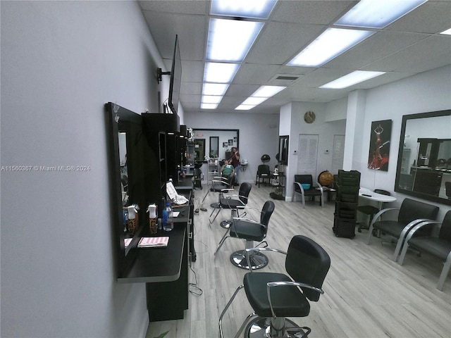 office space with a drop ceiling and light hardwood / wood-style flooring