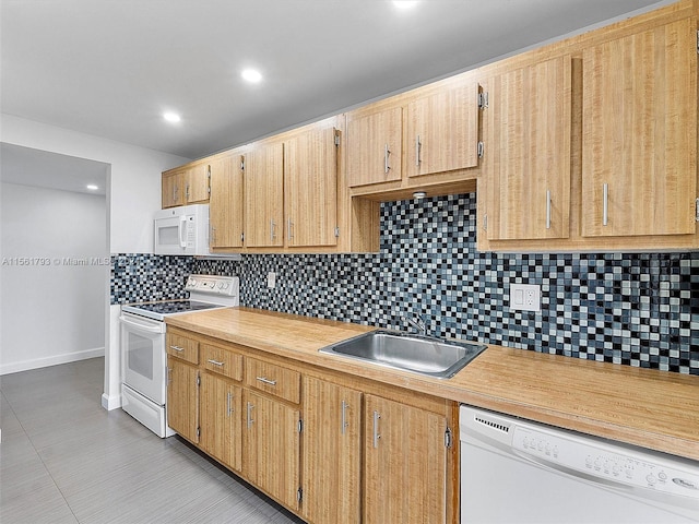 kitchen featuring light tile flooring, tasteful backsplash, white appliances, and sink