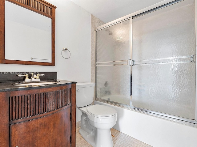 full bathroom featuring combined bath / shower with glass door, toilet, vanity, and tile flooring