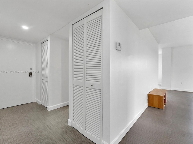 corridor with dark tile flooring