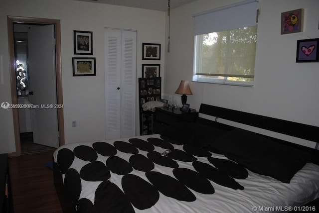 bedroom featuring a closet and dark hardwood / wood-style flooring