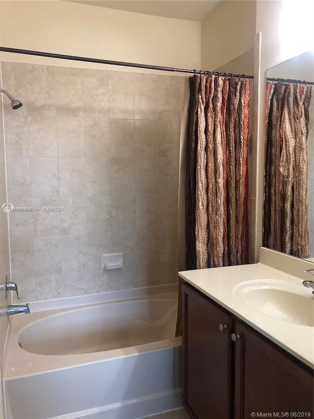 bathroom featuring vanity and shower / bath combination with curtain