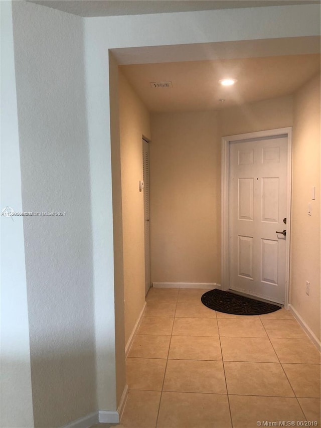 corridor with light tile floors