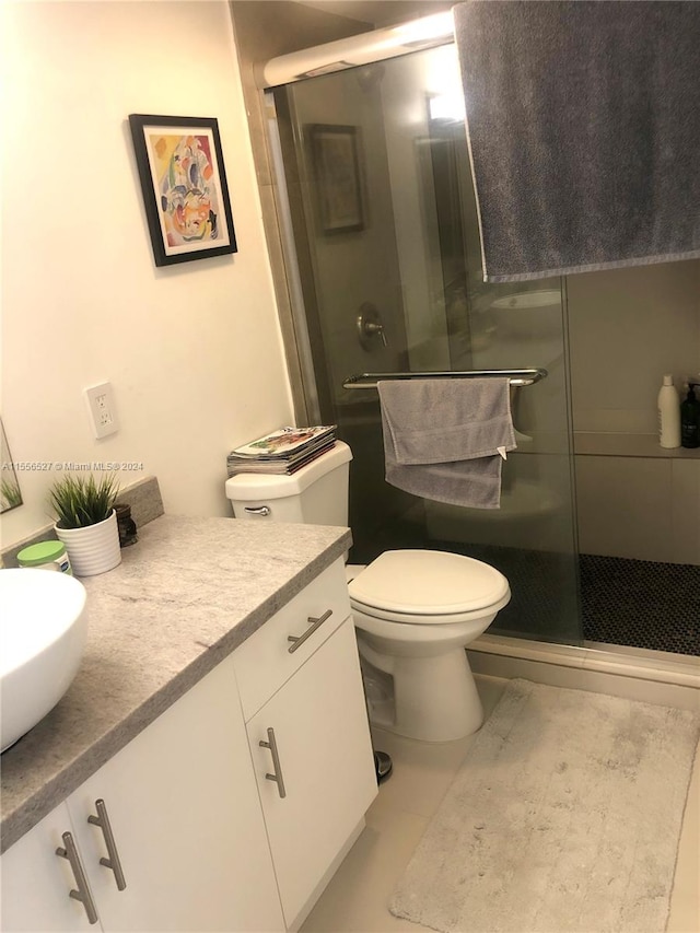 bathroom featuring vanity, tile flooring, and toilet