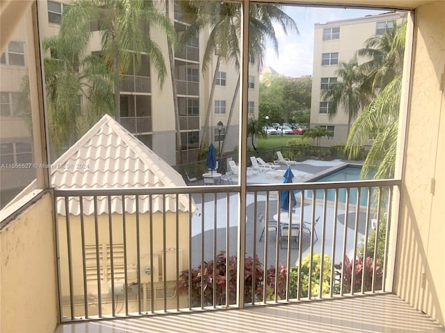 balcony featuring a community pool