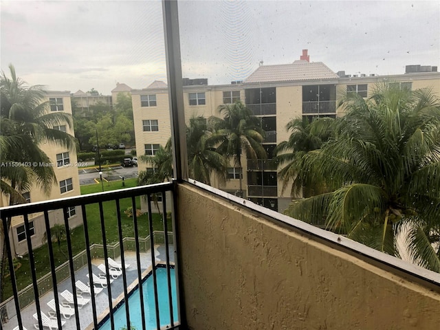 balcony featuring a community pool