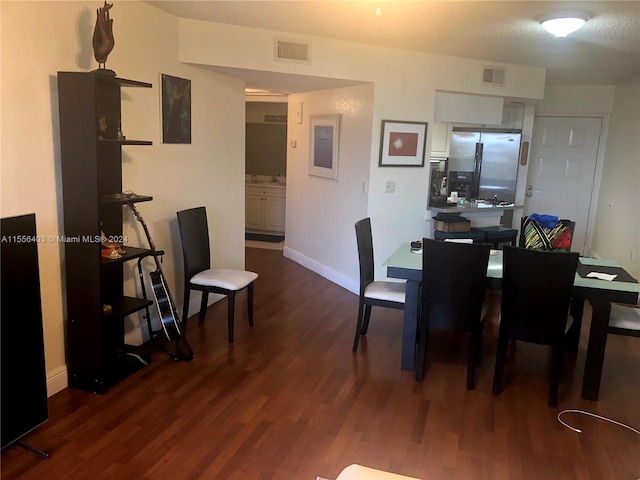 dining space featuring dark hardwood / wood-style floors