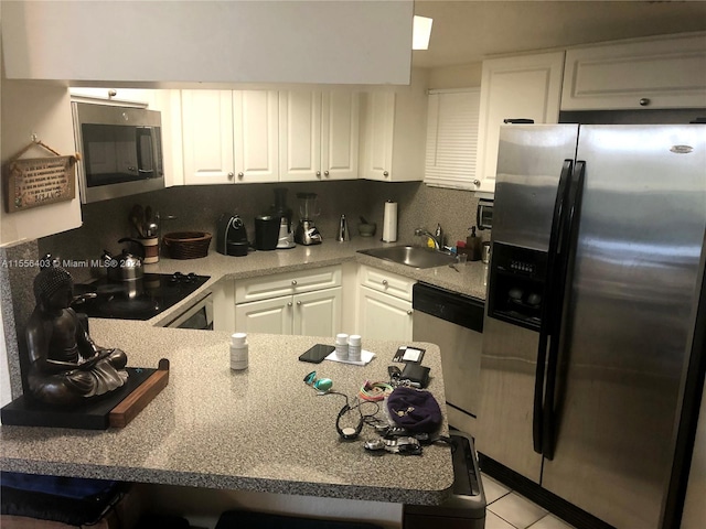 kitchen featuring white cabinets, tasteful backsplash, sink, and stainless steel appliances