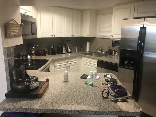 kitchen with backsplash, white cabinetry, appliances with stainless steel finishes, and sink