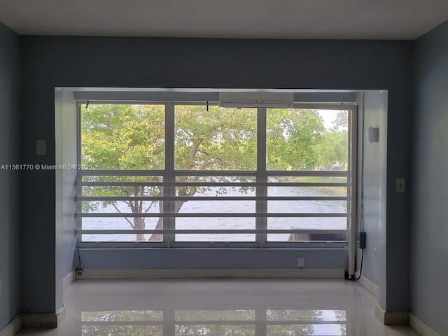 doorway to outside featuring baseboards