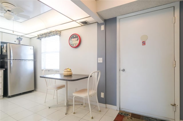 tiled dining space featuring ceiling fan