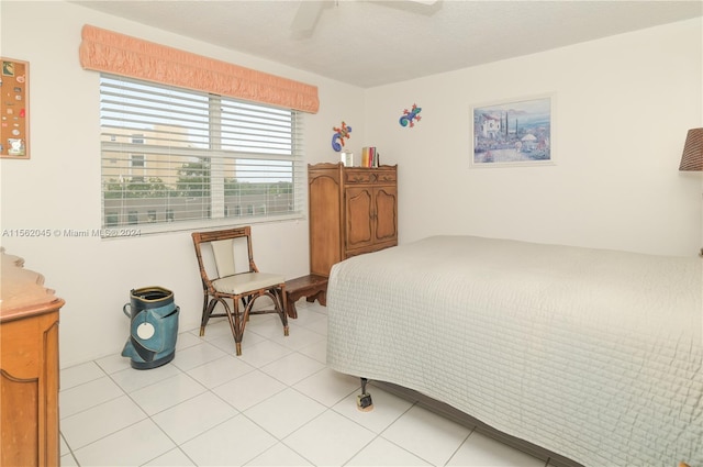 tiled bedroom featuring ceiling fan