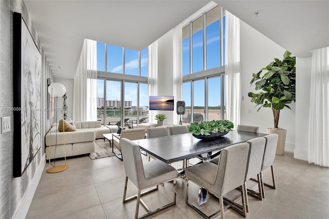 tiled dining space with a high ceiling