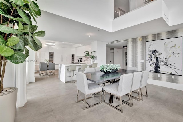 tiled dining room featuring a high ceiling