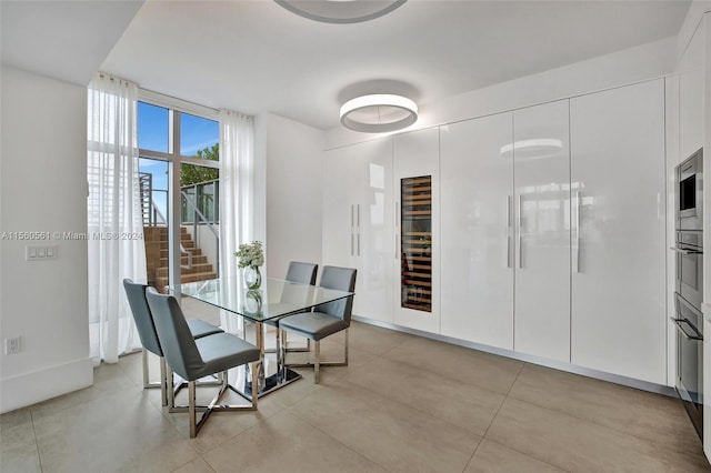 tiled dining room with floor to ceiling windows