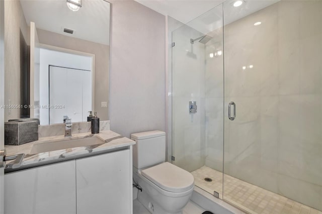 bathroom with an enclosed shower, toilet, and vanity