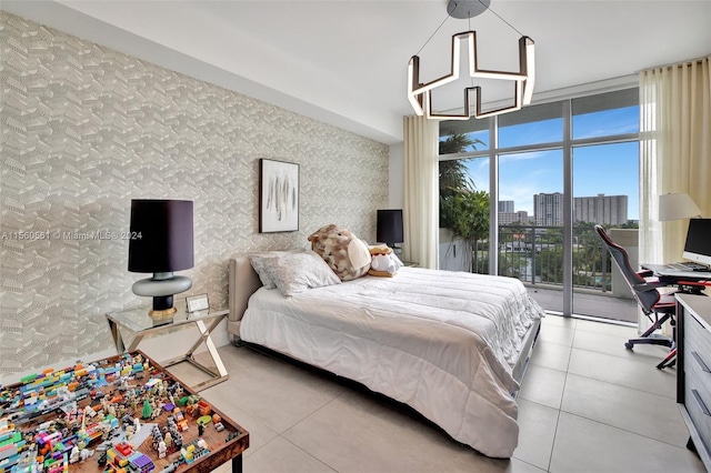 bedroom with a notable chandelier, expansive windows, light tile flooring, and access to outside