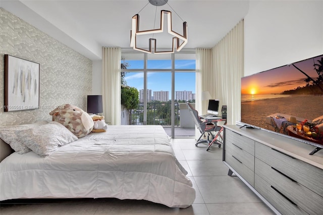 bedroom with access to outside, floor to ceiling windows, and light tile floors