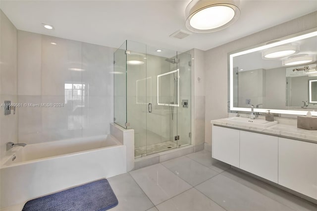 bathroom featuring separate shower and tub, vanity, and tile floors